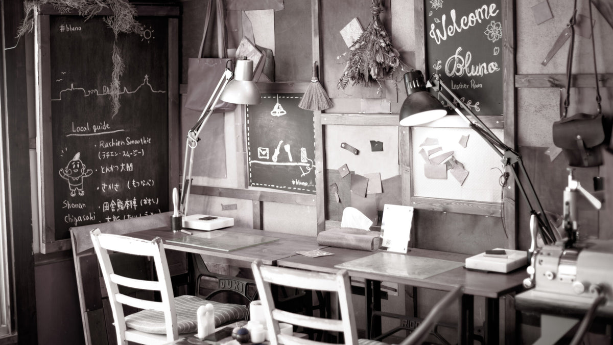 Leather, tools, and worktables in the Bluno atelier