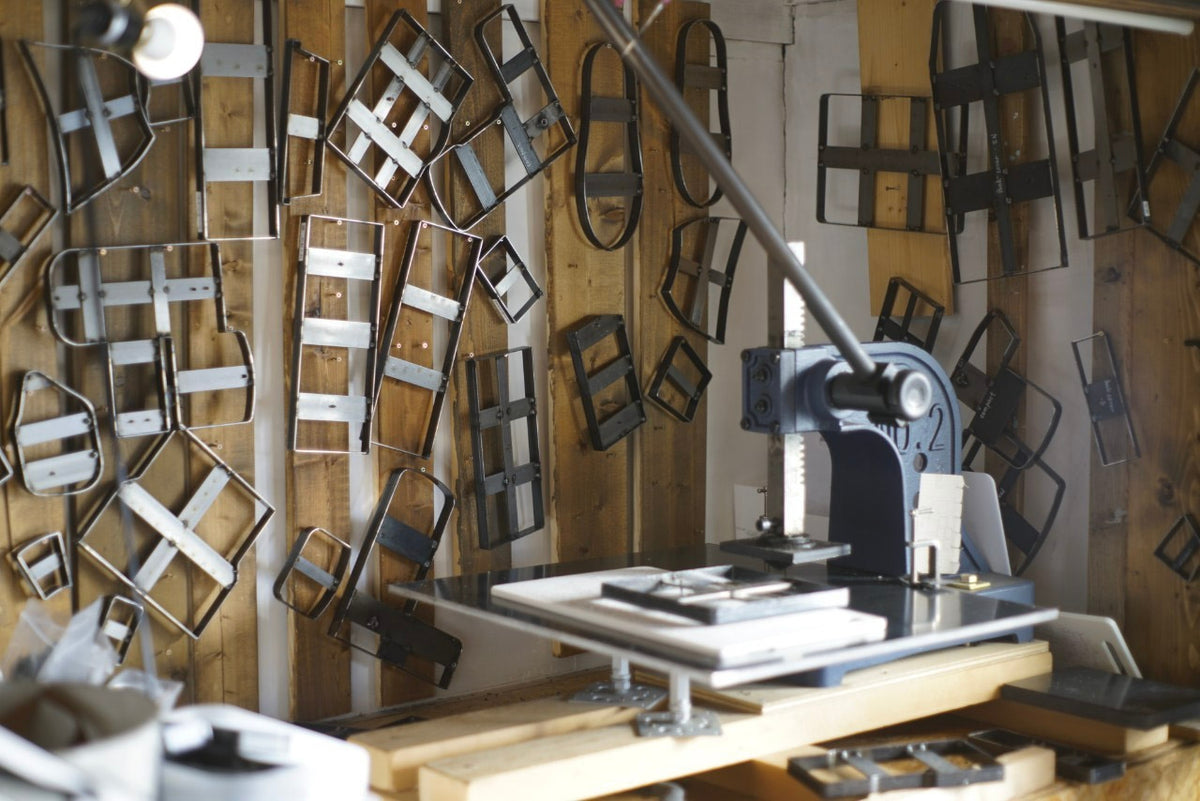 Leather cutting dies and tools in an atelier filled with natural light
